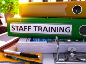 Staff Training - Green Office Folder on Background of Working Table with Stationery and Laptop. Staff Training Business Concept on Blurred Background. Staff Training Toned Image. 3D..jpeg